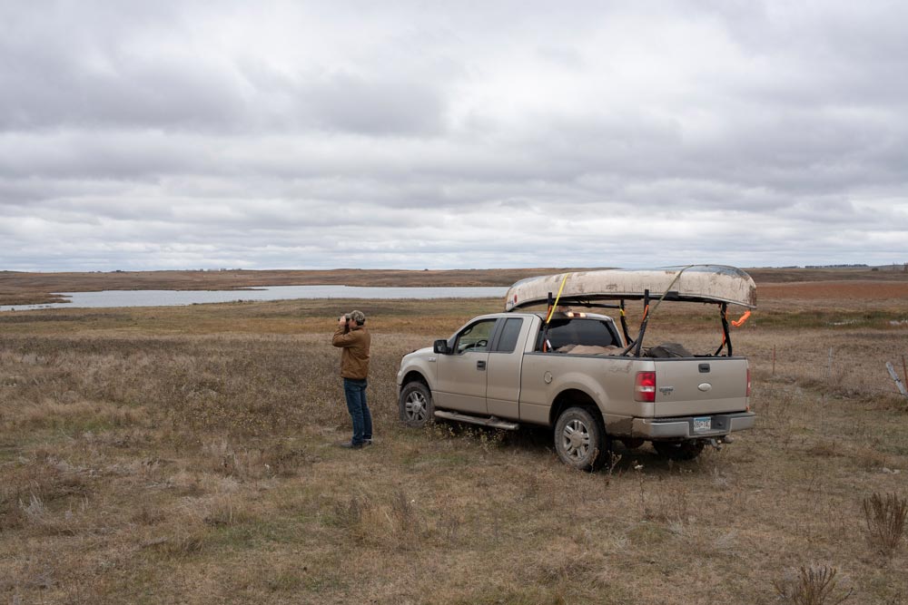 one hunter scouting a field next to his truck