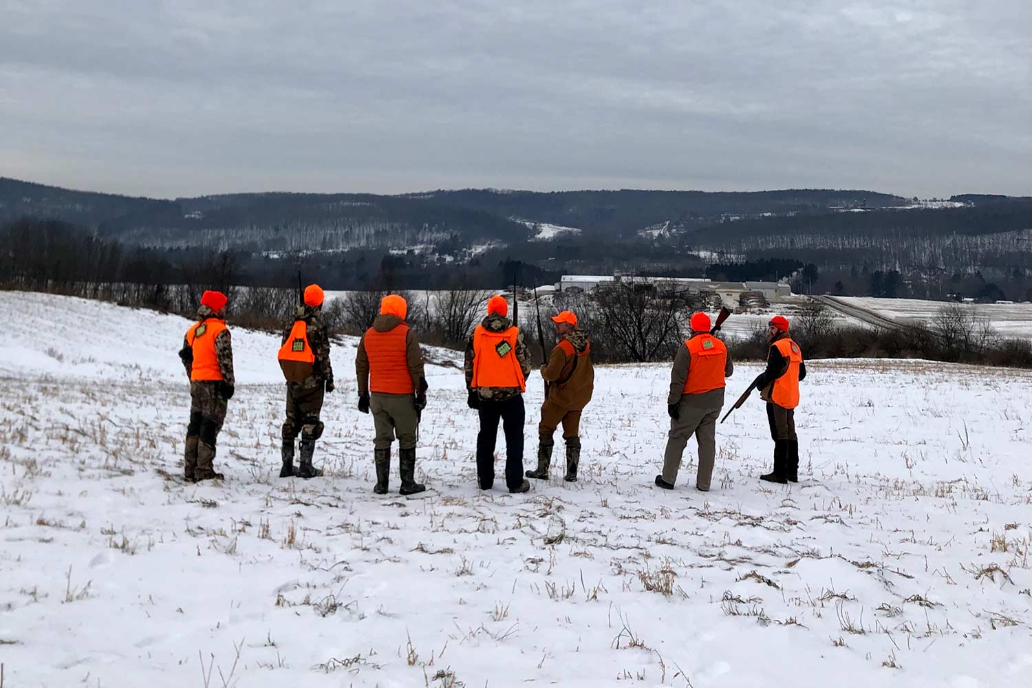 Hunters standing in the snow.