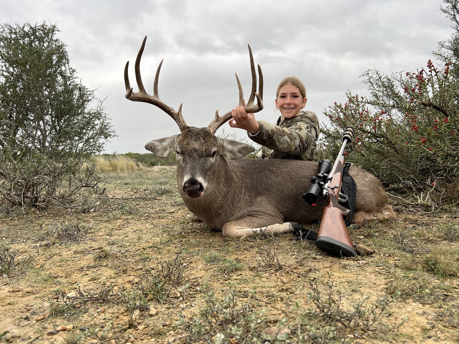 Stormy Cunningham holds up her whitetail buck.