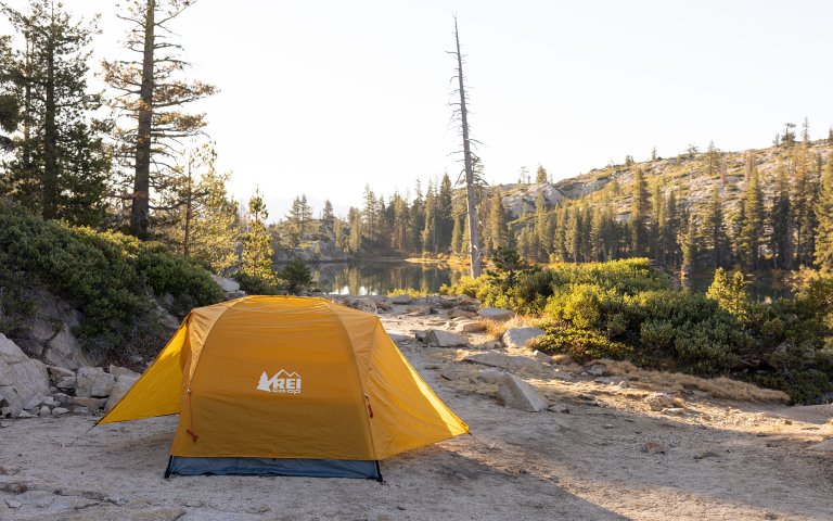 REI Half dome set up by an alpine lake